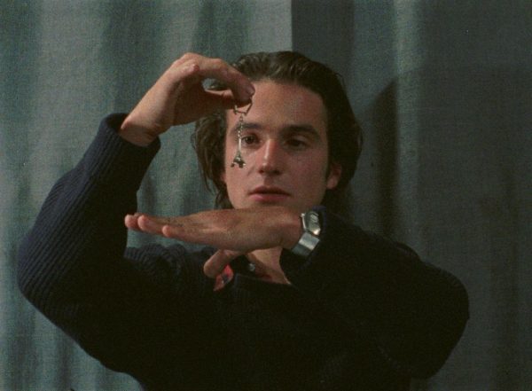 Colin (Jean-Pierre Léaud) experiments with a 'pendulum' – actually a Tour Eiffel keyring.